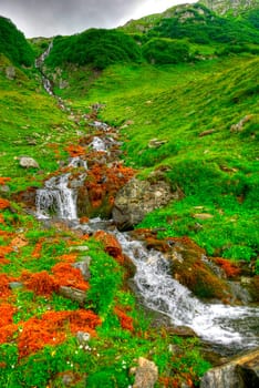 beautiful long watterfall. cascade in the morning sun light,  HDR.