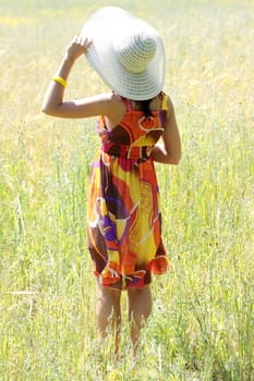 Young happy woman in green grain field