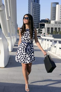 Beautiful brunette shopaholic outdoor modern city urban street