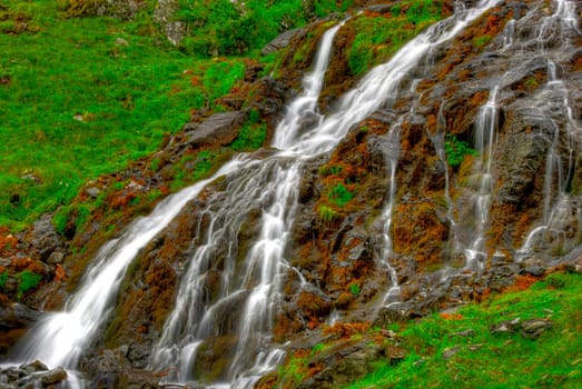 beautiful cascade in the morning light,  HDR. Long exposure time gives an "out of time"" feeling."