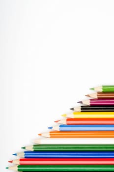 Assortment of coloured pencils with shadow on white background