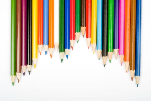 Assortment of coloured pencils with shadow on white background