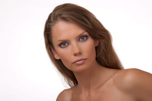 Portrait close up of the young woman of the European type with blue eyes, on a white background