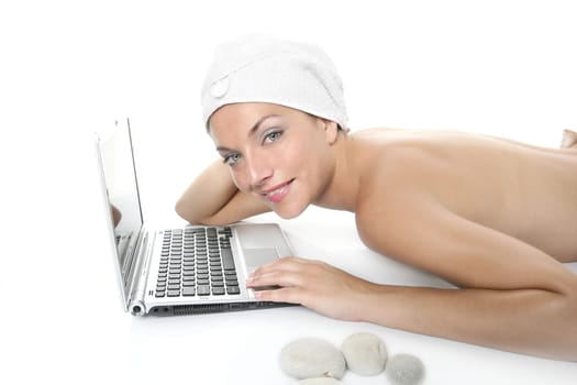 Beautiful woman in spa working with laptop computer