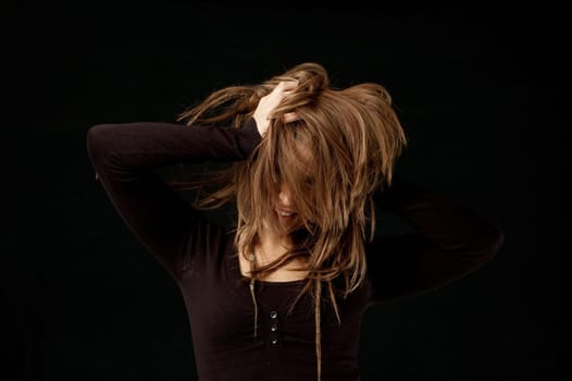 Hair flick against black background