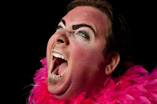 Clown yelling against black background