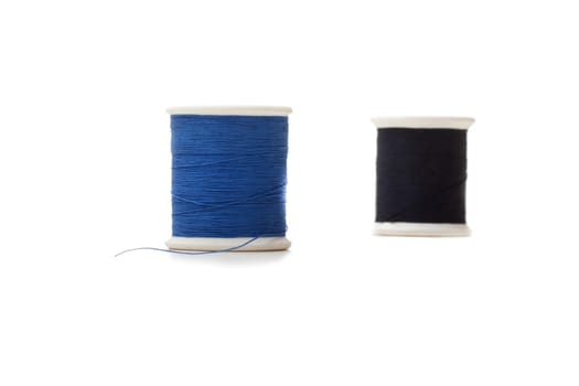 two rolls of sewing cotton isolated on white
