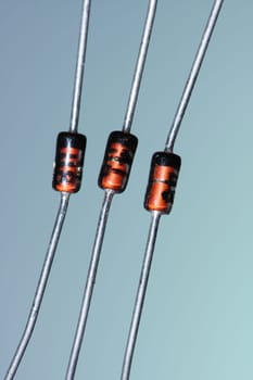 Three zener diodes against a blue-green background.