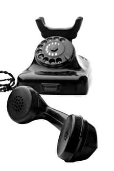 old vintage black rotary telephone isolated on white