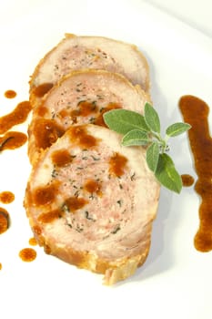 Three slice of roasted meat with sage and garnish