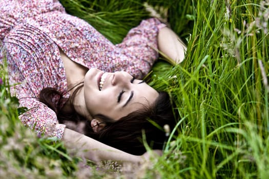 Photo Of A Cute Girl Lying On Grass Field