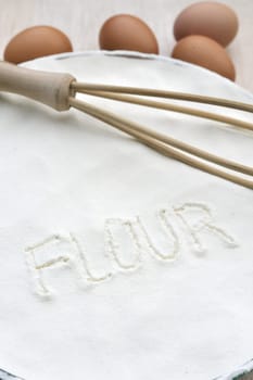 Word "flour"" handwritten in flour"