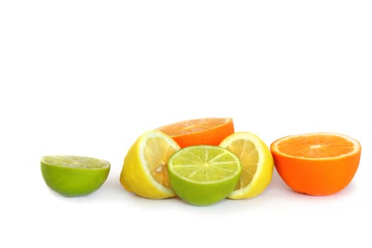 Orange, lemon and lime citrus fruits halves, over white background.