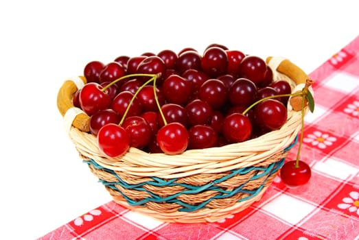 ripe cherry  in wicker on white background