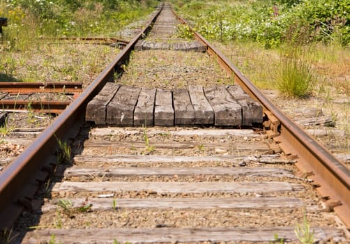 A pair of railroad tracks stretching off in a dtraight line o infinity. This kind of image is symbolic to many linked activities in business duch as receding goals, etc.