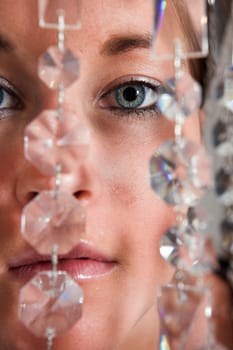 Young attractive Woman eyes closeup with glitter chain