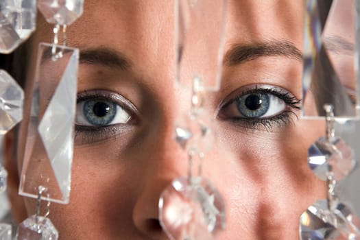 Young attractive Woman eyes closeup with glitter chain