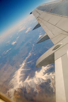 Beautiful mountain ridge under the wing of airplane