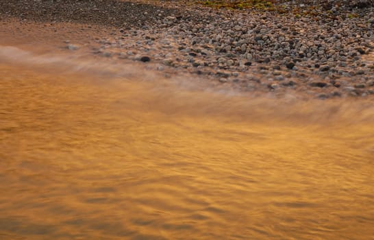 the evening surf coloured by sun set