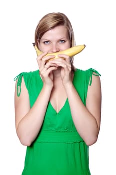 beautiful blonde young girl holding a banana like a smile in front her mouth, isolated on white