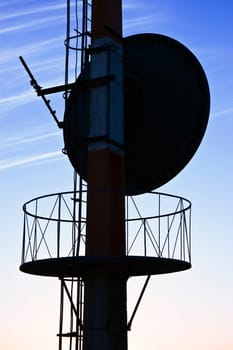 Telecommunications antenna against a clear blue sky