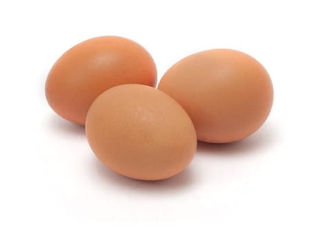 Three yellow chicken eggs on white background