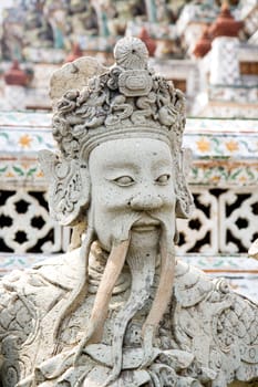 Guardian statue at the Buddhist temple of Wat Arun in Bangkok, Thailand.