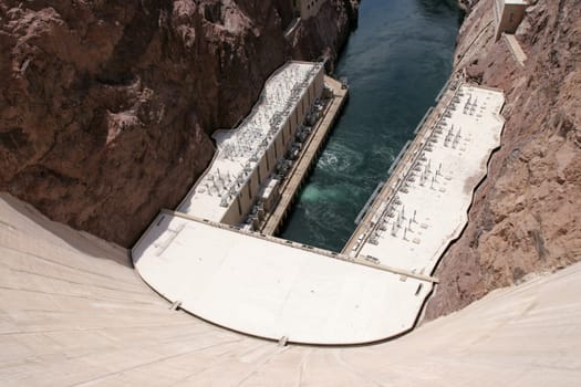 View of down Hoover Dam at hydroelectric powerplant and Colorado River.