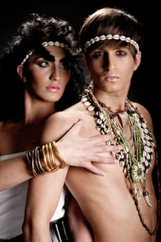 Couple in love posing against black background