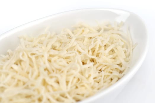 Grated cheese on the white plate