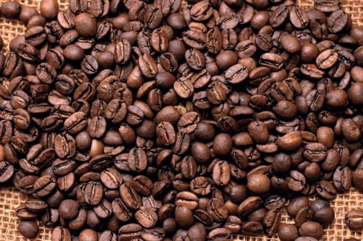 roasted coffee beans on a bag. vertical photo