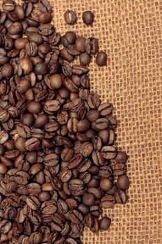 roasted coffee beans on a bag. vertical photo