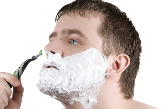 Man shaving razor with foam on white
