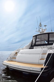 Rear view of white luxury yacht, blue sky and sea