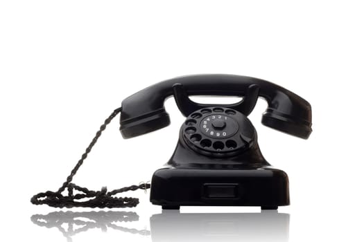 old vintage black rotary telephone isolated on white