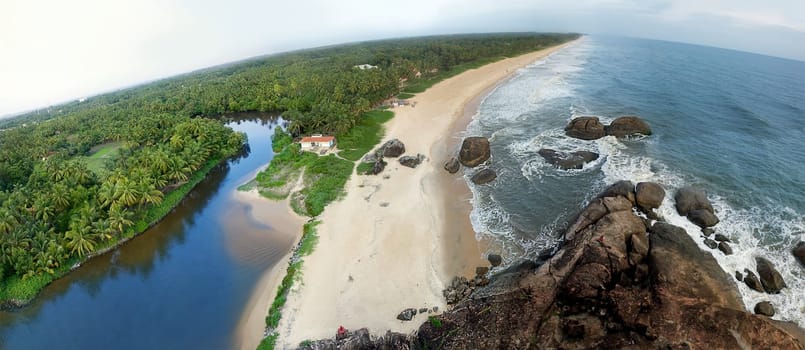 A beautiful landscape of beach having palm tree and house