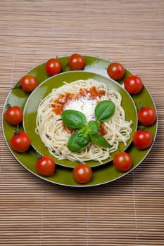Pasta with tomato sauce basil and grated parmesan