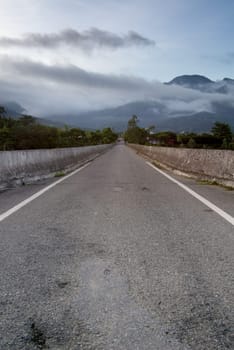 It is a contry road in the morning.