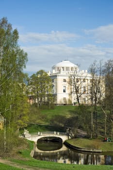 View of classical palace and bridge in picturesque park