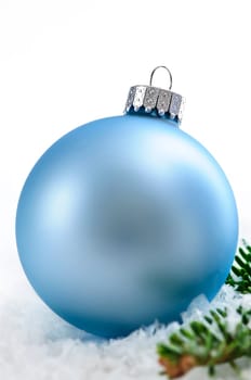 Blue Christmas decoration in snow with pine branches