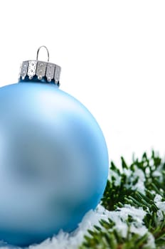Blue Christmas decoration in snow with pine branches