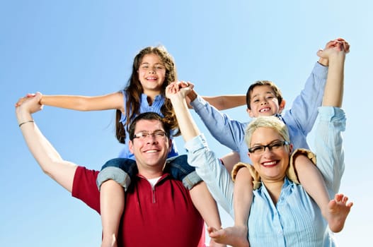 Happy family having fun giving shoulder rides