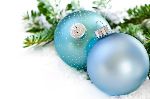 Two Christmas decoration in snow with pine branches