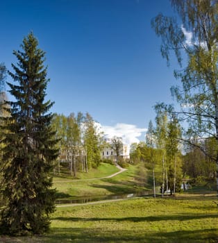 Spring park with classical building and river behind