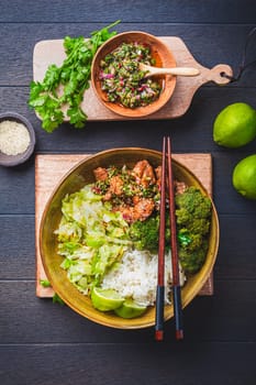 Chicken bowl with rice, broccoli, cabbage and green Chimmichurri salsa