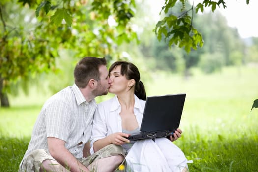 happy young couple relaxing in park