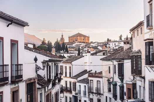 Views of the medieval village of Ronda with white Andalusian houses and the gothic style church of Santuario de Mar a Auxiliadora. Malaga, Spain