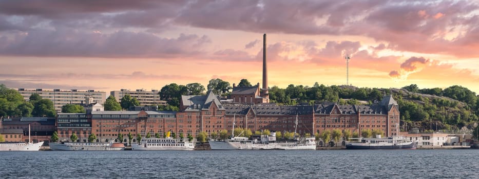 Hammarby Sjo bay, with Munchenbryggeriet Congress Center in the frame, located at the eastern part of the city of Stockholm, Sweden, at sunset in summer time