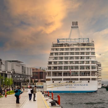 Istanbul, Turkey - May 5, 2023: SEVEN SEAS VOYAGER, Large cruise ship docked at terminal of Galataport, a mixed use development located along shore of Bosphorus, in Karakoy neighbourhood before sunset