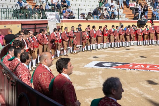 March 26, 2023 Lisbon, Portugal: Tourada - bullfighters stand at the walls of the round arena of the amphitheater. Mid shot